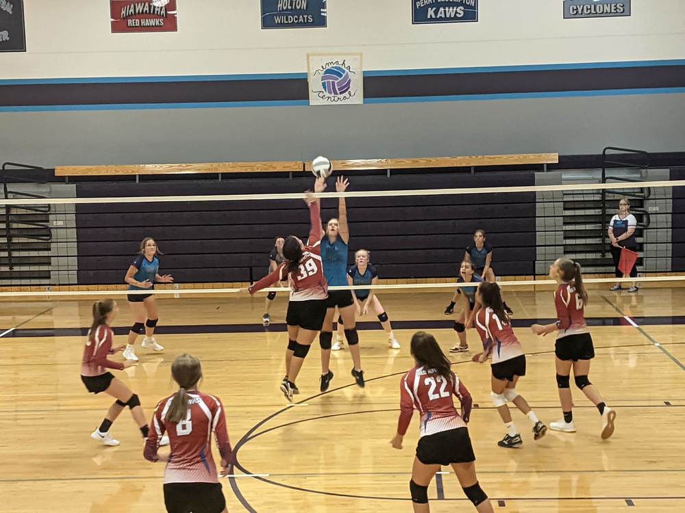 NCMS volleyball player Ali Lueger goes up for a block against the opponet the Hiawatha Red Hawks