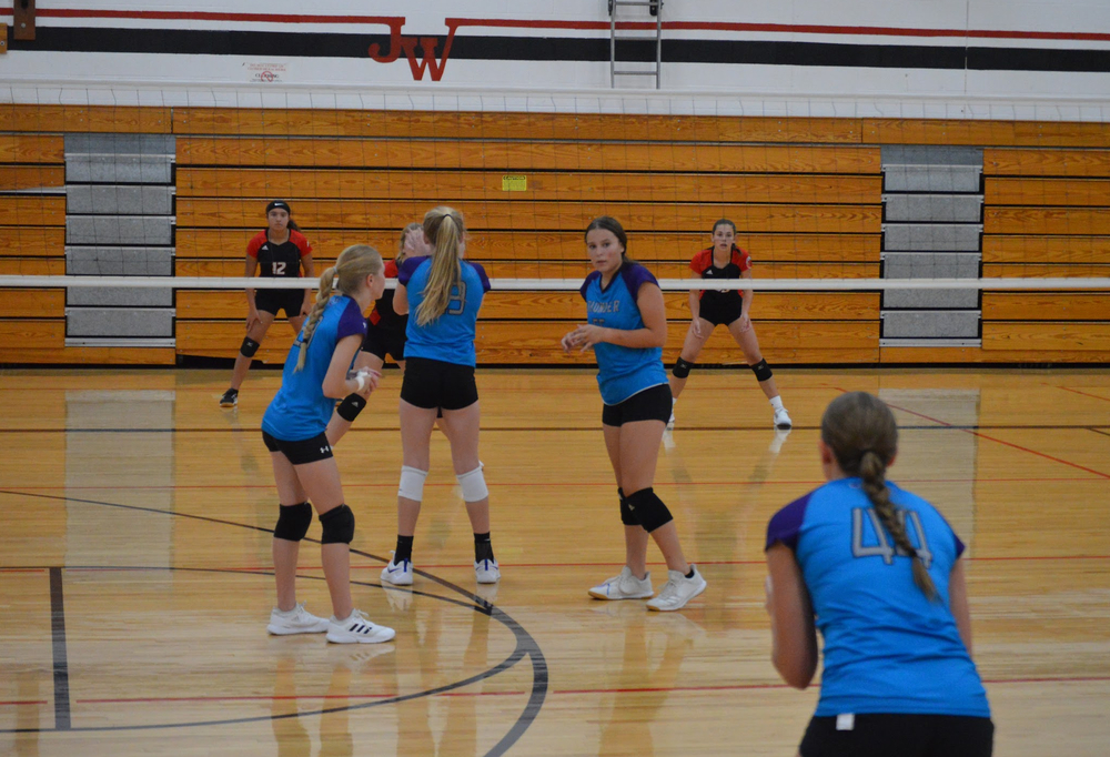 NCMS volleyball girls getting ready to serve the ball.