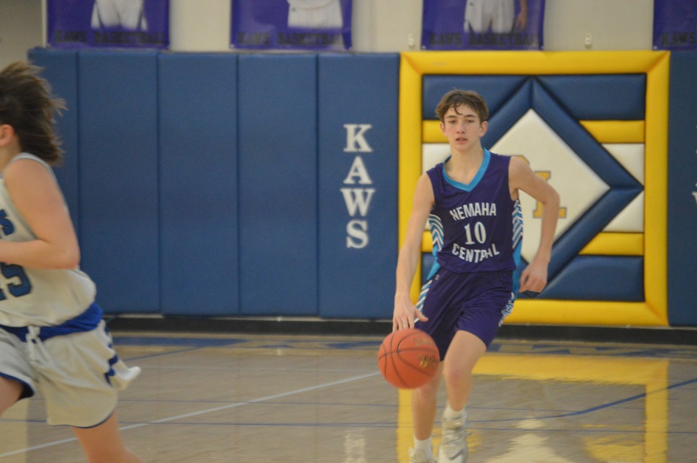 8th grader Brady Koch takes the ball up the court.