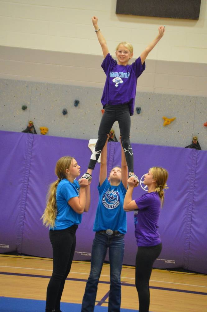 Zoey Lockhart being held in the air with the help of her friends
