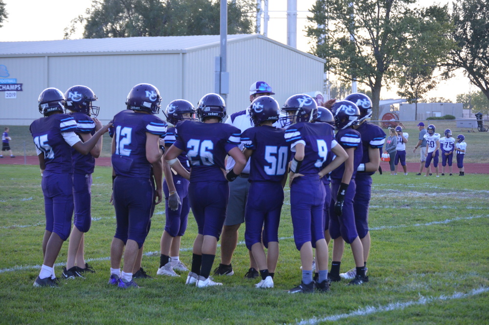 Nemaha Central Thunder talk with a coach before kicking off.